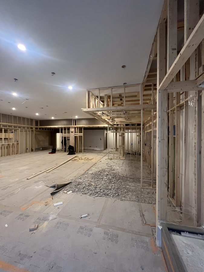 Bulkhead framing being built below a finished ceiling with pot lights